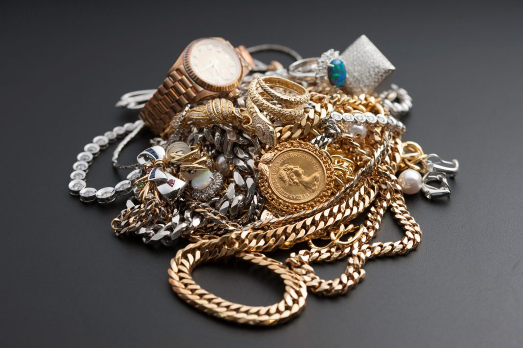 Image of a pile of jewelry against a grey background.