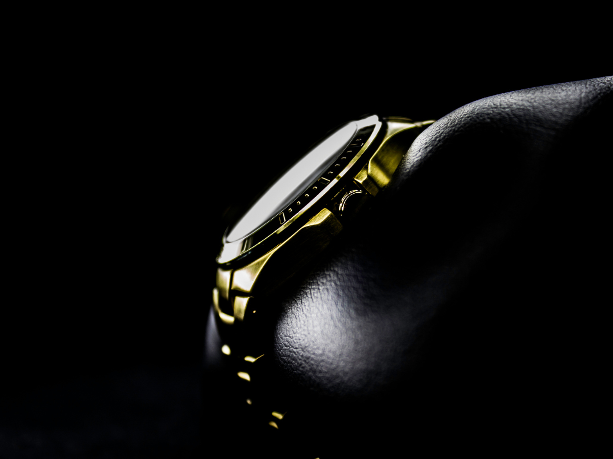 Image of gold watch against black background